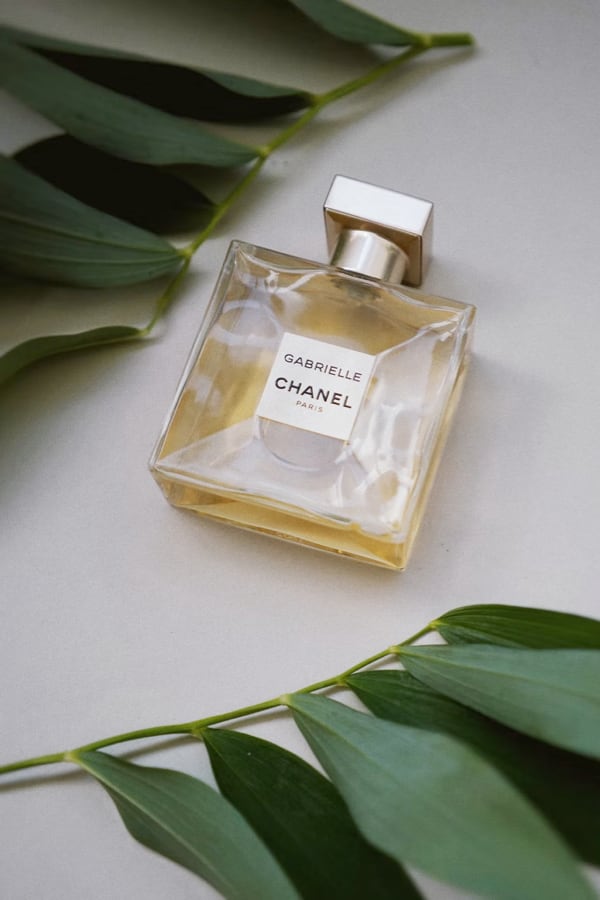 perfume surrounded by leaves